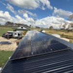 Expansive rooftop solar panel system, designed for maximum energy efficiency under clear skies.