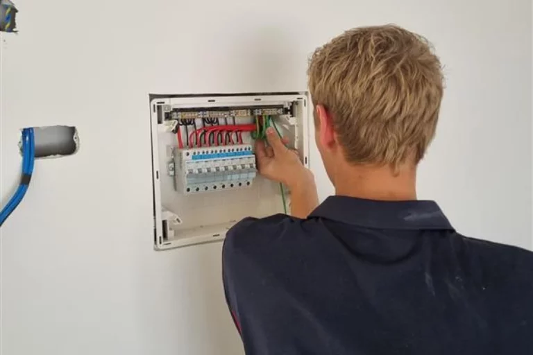 Electrician working on a switchboard installation, ensuring a safe and efficient electrical system.