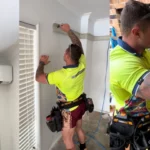 Technician installing and servicing an air conditioning system, ensuring a professional and efficient setup.