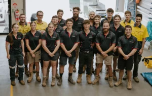 The Bright Spark Group team standing together in their workshop, representing expertise in electrical and solar solutions.
