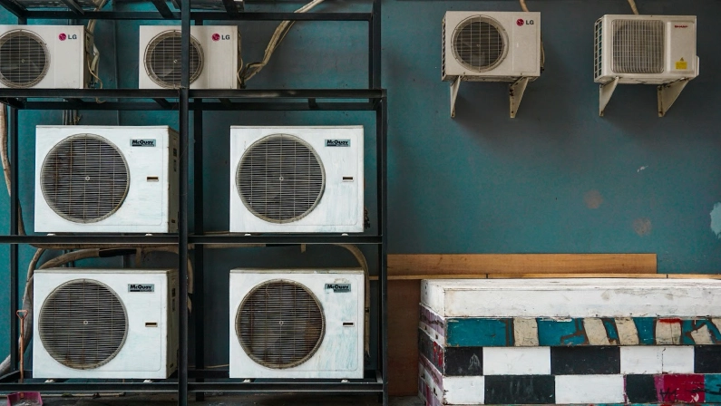 A row of air conditioning units in different sizes and models shows the options to consider when purchasing or upgrading your air conditioner.