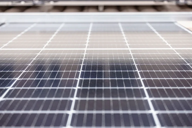Close-up view of solar panel surface showing cell texture and detail.