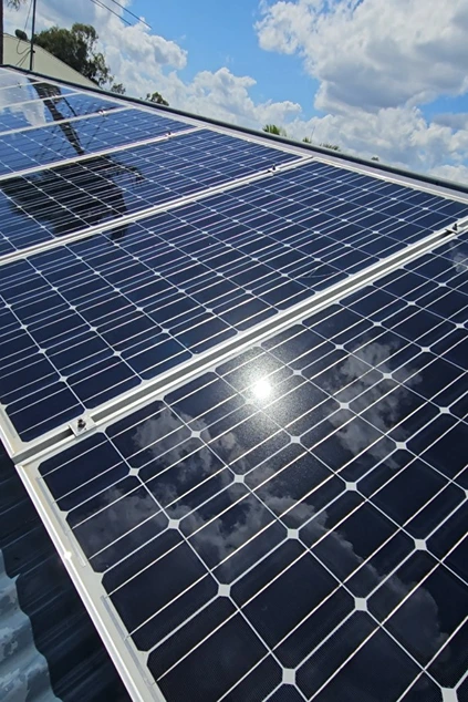 Close-up of solar panels with sunlight reflecting across the glass