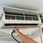 Air conditioning unit being serviced by the Bright Spark Group team