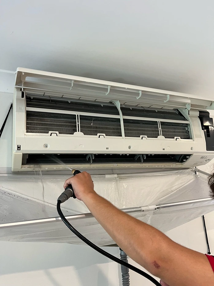 Air conditioning unit being serviced by the Bright Spark Group team