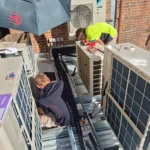 Bright Spark technicians performing detailed repairs on outdoor air conditioning systems, reflecting expert AC repair services.
