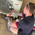 Bright Spark professional conducting maintenance checks and diagnostics on an air conditioning unit to ensure optimal performance.
