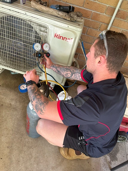 Bright Spark professional conducting maintenance checks and diagnostics on an air conditioning unit to ensure optimal performance.