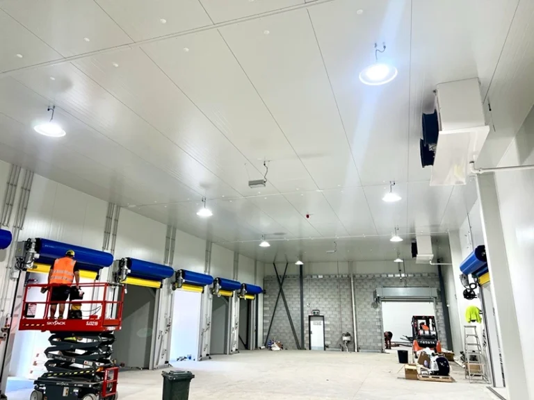 Brightly lit commercial interior with overhead lighting, showcasing a professional electrical fit-out.
