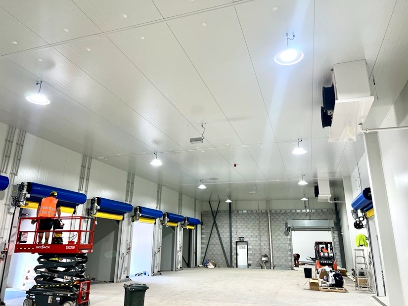 Brightly lit commercial interior with overhead lighting, showcasing a professional electrical fit-out.