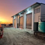 Commercial facility at dusk with visible backup power systems, showcasing robust energy planning and emergency readiness.
