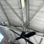 Ceiling view of residential electrical work featuring ducted air conditioning and ceiling fan installation for climate control and comfort.