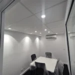 Completed office electrical installation with recessed lighting and split-system air conditioning, highlighting energy-efficient climate control.