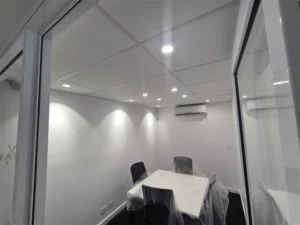 Completed office electrical installation with recessed lighting and split-system air conditioning, highlighting energy-efficient climate control.