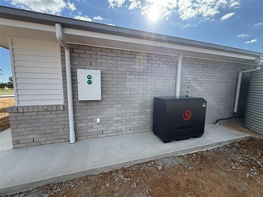 Outdoor solar battery backup system installed beside a modern brick home in Queensland