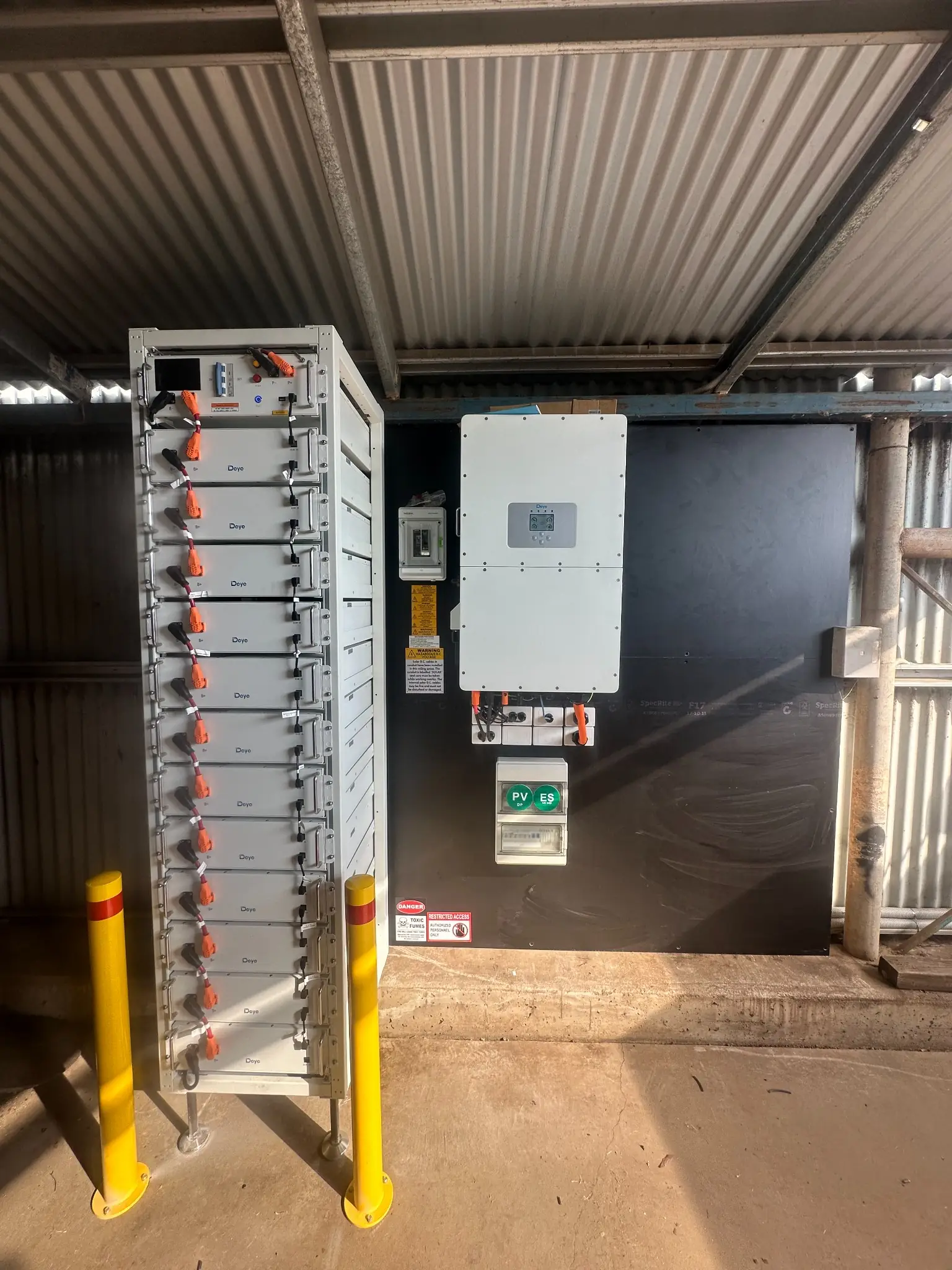 Solar battery energy storage system installation by Bright Spark Group with integrated inverter and safety switch setup.