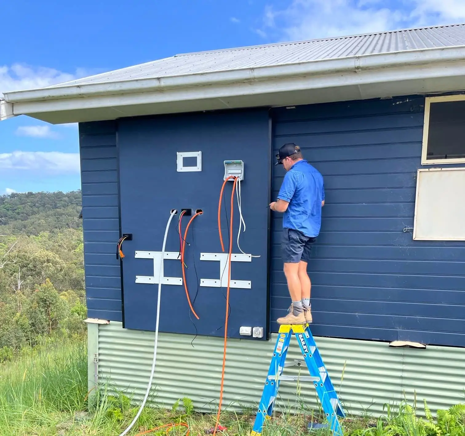 Bright Spark Group solar system maintenance technician servicing off-grid home solar battery and energy storage system installation