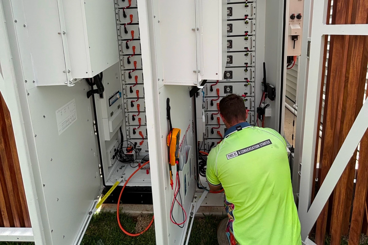 Technician servicing solar battery rebate system installation