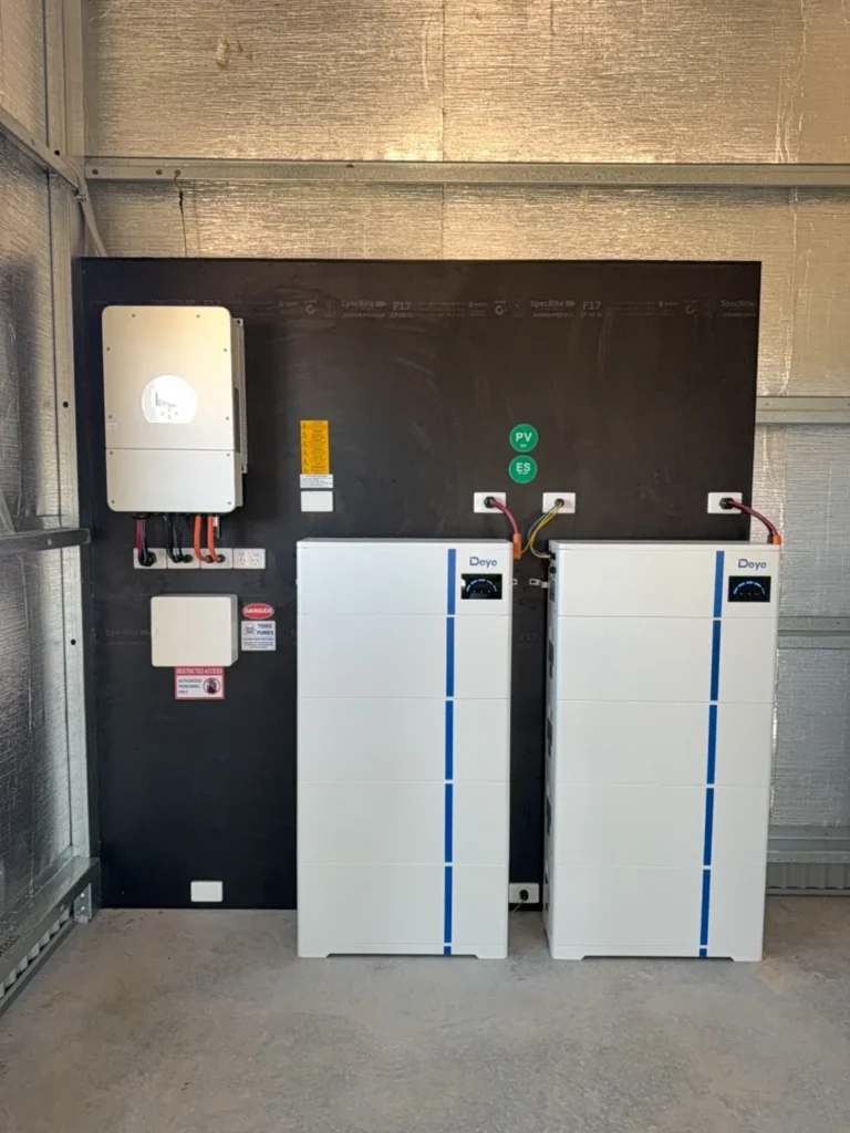Deye solar battery storage system installation featuring dual white lithium battery towers and wall-mounted inverter for residential renewable energy storage solution