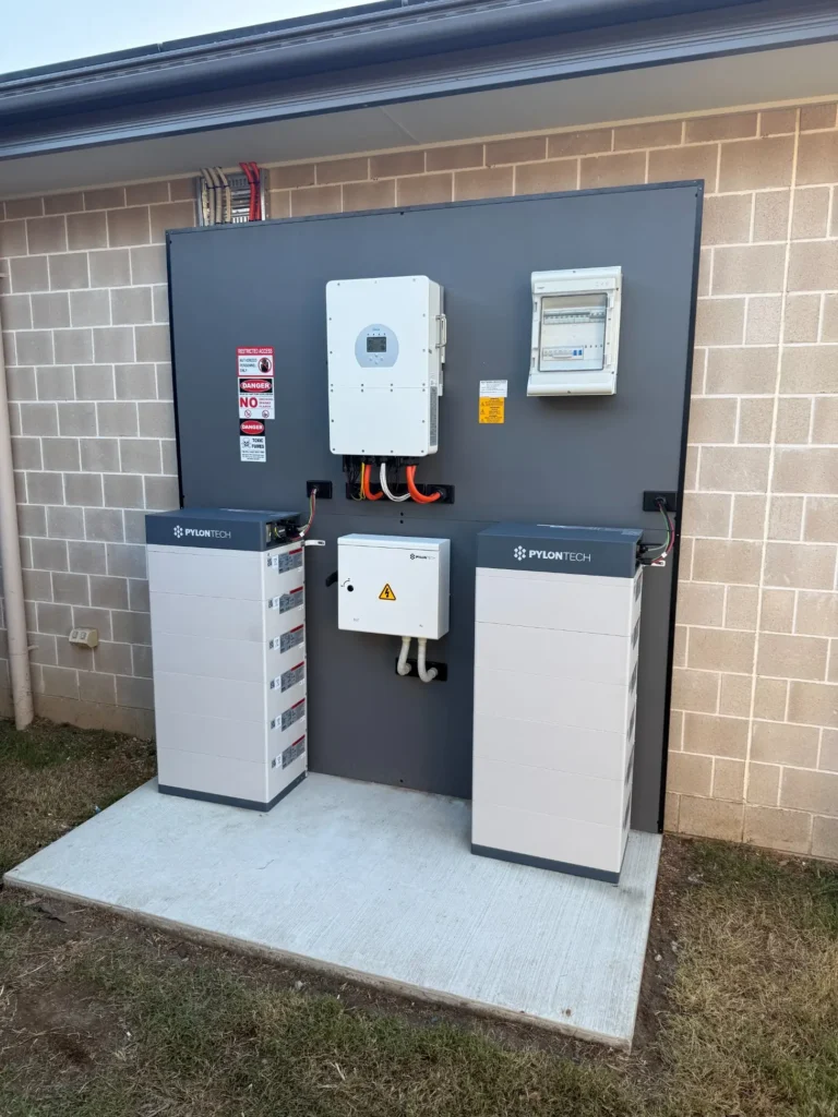 Bright Spark Group outdoor solar battery installation featuring Pylontech battery system and Deye hybrid inverter mounted on external wall in Brisbane residential property