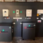 RedEarth Energy Storage home battery system installation with dual black lithium battery units and solar inverter mounted on wall for residential solar power backup