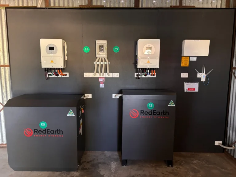 RedEarth Energy Storage home battery system installation with dual black lithium battery units and solar inverter mounted on wall for residential solar power backup