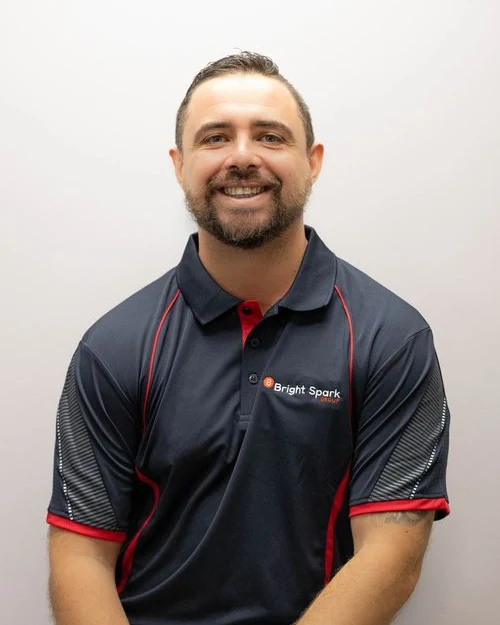 Bright Spark Group electrician team member in branded BSG work shirt