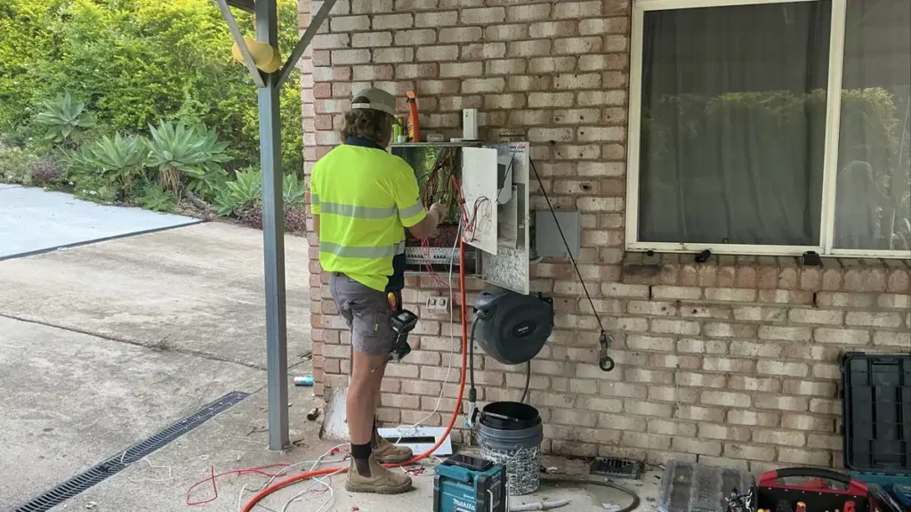 Bright Spark Group electrician working on outdoor power installation at a Queensland home