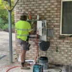Bright Spark Group electrician working on outdoor power installation at a Queensland home