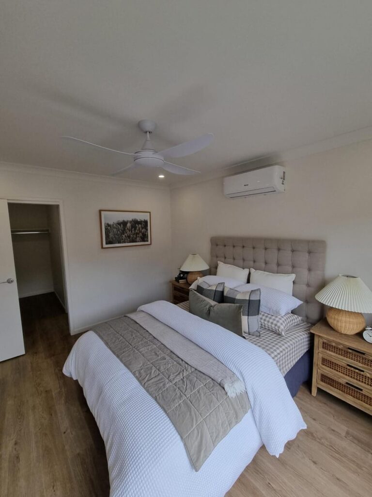 Bedroom with a ceiling fan, downlights and a split system air conditioner
