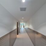New commercial corridor with downlights and ceiling lighting installed