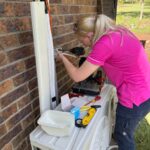 Electrician installing an isolator at an outdoor air conditioning unit
