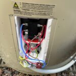 Hot water system thermostat and element wiring with the cover open