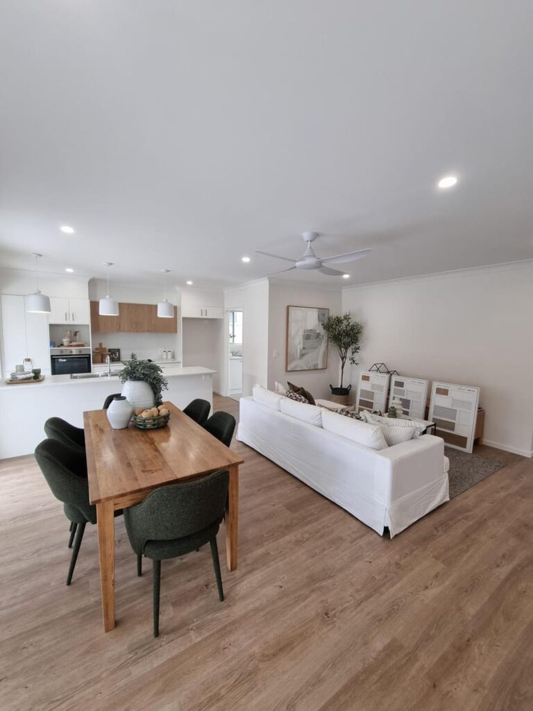 Open-plan living area with downlights, pendant lights and a ceiling fan