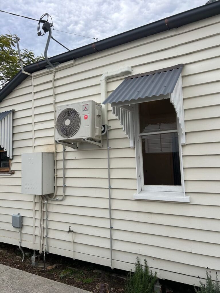 Mitsubishi Heavy Industries outdoor unit installed on an older weatherboard Queensland home