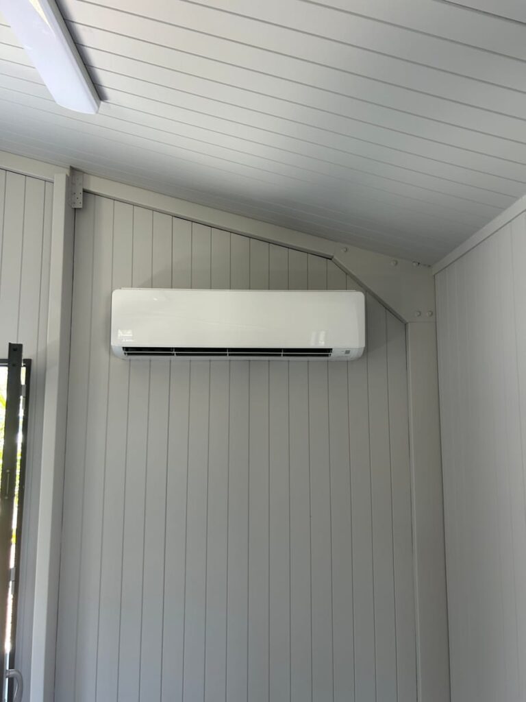 Mitsubishi split system air conditioner installed in a bright lined room