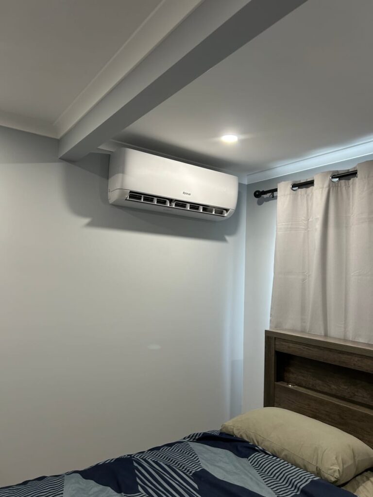 Rinnai split system air conditioner installed on a bedroom wall