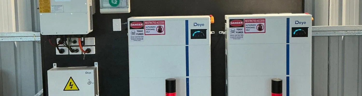 Two stacked Deye battery units and a Deye inverter installed on a wall