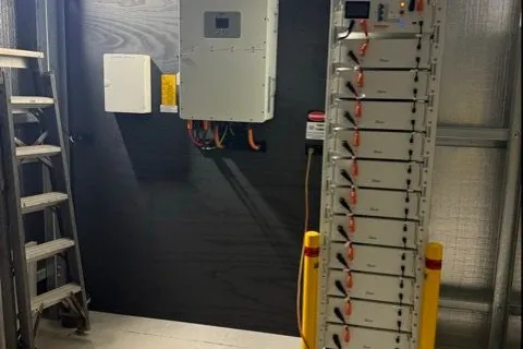 Deye hybrid inverter and tall rack battery in a garage, installed by Bright Spark Group