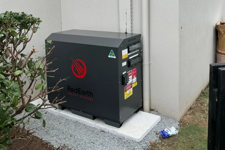 Home battery unit installed beside a house on a concrete pad, installed by Bright Spark Group