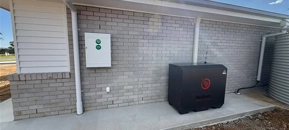 Wall-mounted solar battery and inverter system installed on the exterior of a residential home.