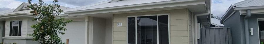 Modern single-story home with a well-maintained lawn and garden.