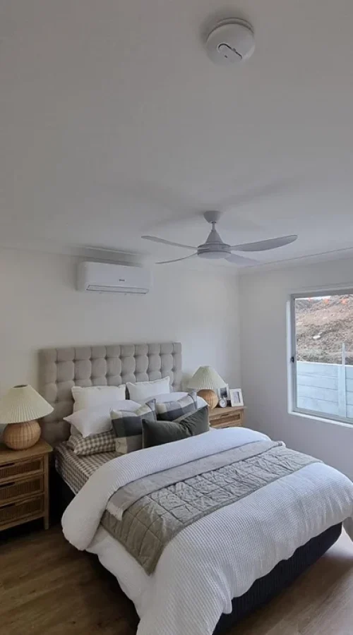 Contemporary Brisbane bedroom with ceiling fan, energy-efficient LED lighting, and upgraded power points professionally installed for residential comfort and safety.