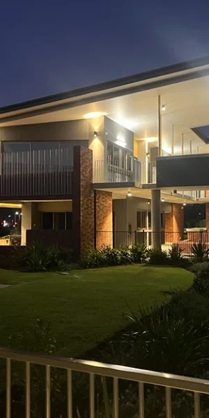 Well-lit modern building exterior at night, demonstrating precise electrical installation and service.