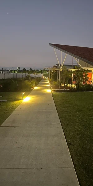 Outdoor pathway illuminated by energy-efficient lighting, highlighting emergency readiness and ongoing maintenance.