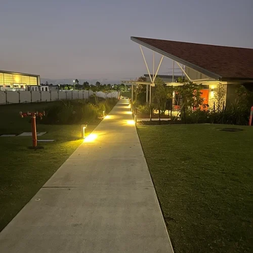 Outdoor pathway illuminated by energy-efficient lighting, highlighting emergency readiness and ongoing maintenance.