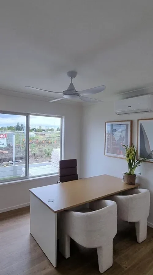 Open-plan Brisbane living room with LED downlights, ceiling fan, and modern electrical fittings installed by residential electricians for energy-efficient home upgrades.
