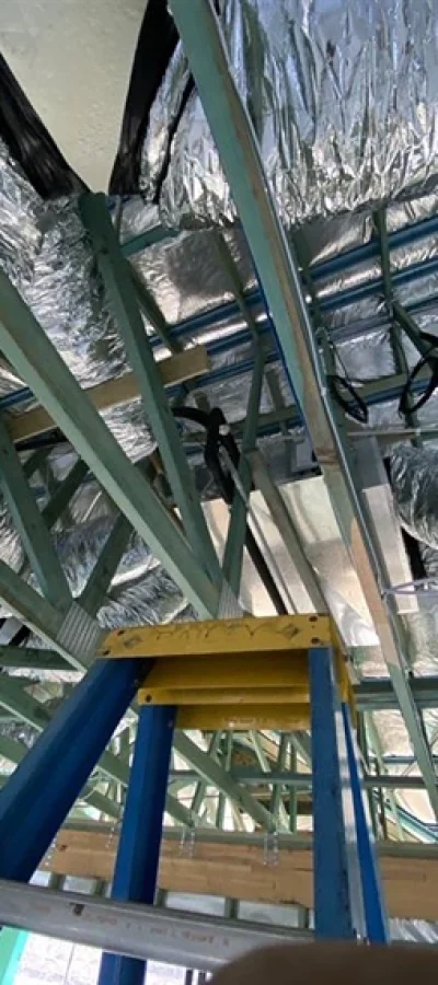 Installation of ducted air conditioning system in a Brisbane home, with ceiling-mounted ducts providing discreet, whole-home climate control.