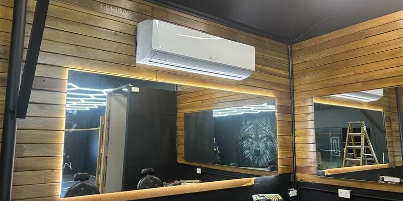 Wall-mounted split system air conditioner installed in a timber-clad Brisbane room, offering targeted, quiet, and energy-efficient cooling for single-room comfort.