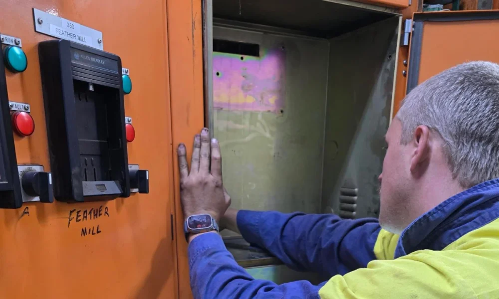 Electrician performing high-voltage maintenance on industrial switchgear, ensuring safe and compliant operation.
